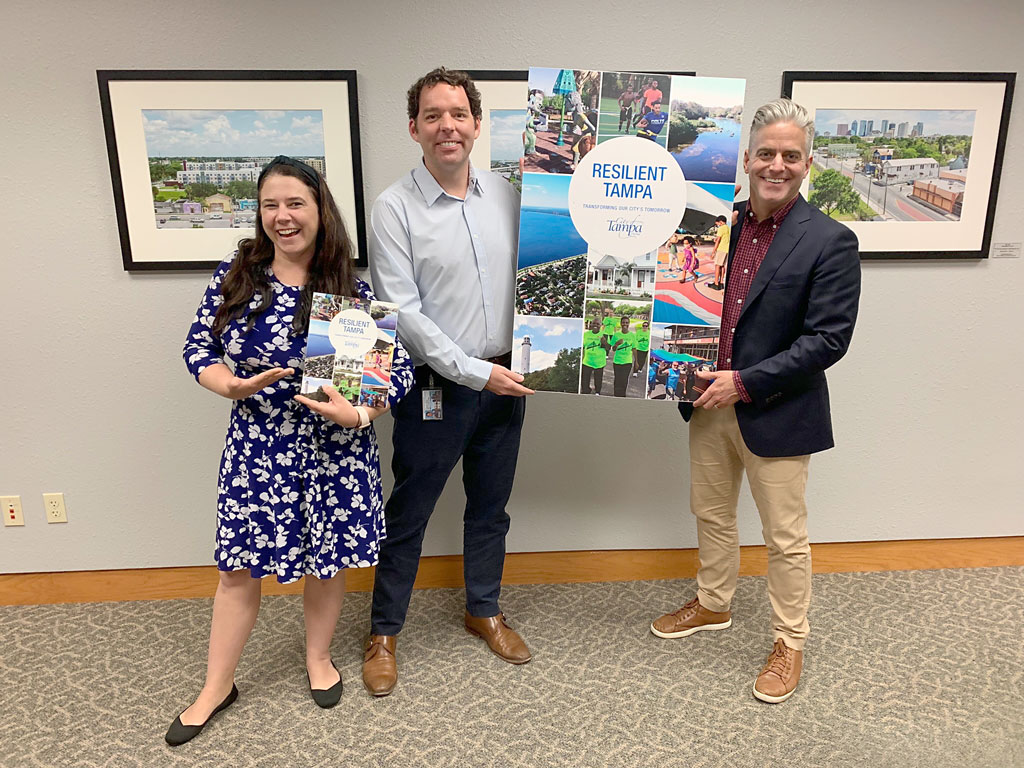 RCC Staff and Tampa City official holding a large poster of the Tampa Resilience Roadmap